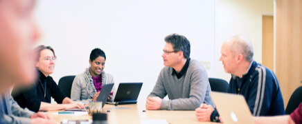 Colleagues talking around a conference table